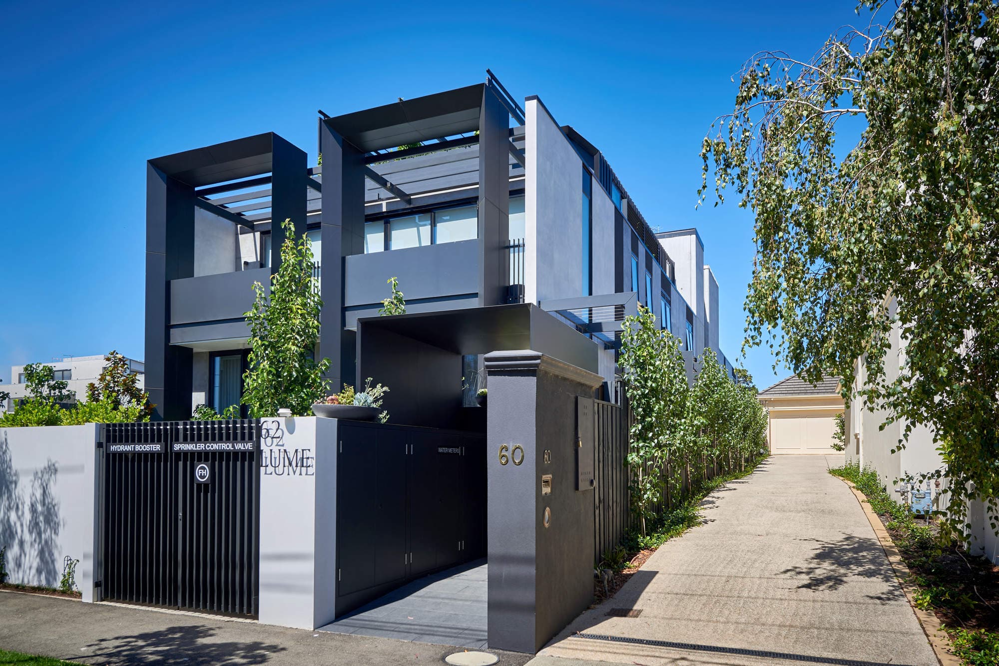 Image of a grey, modern apartment complex.