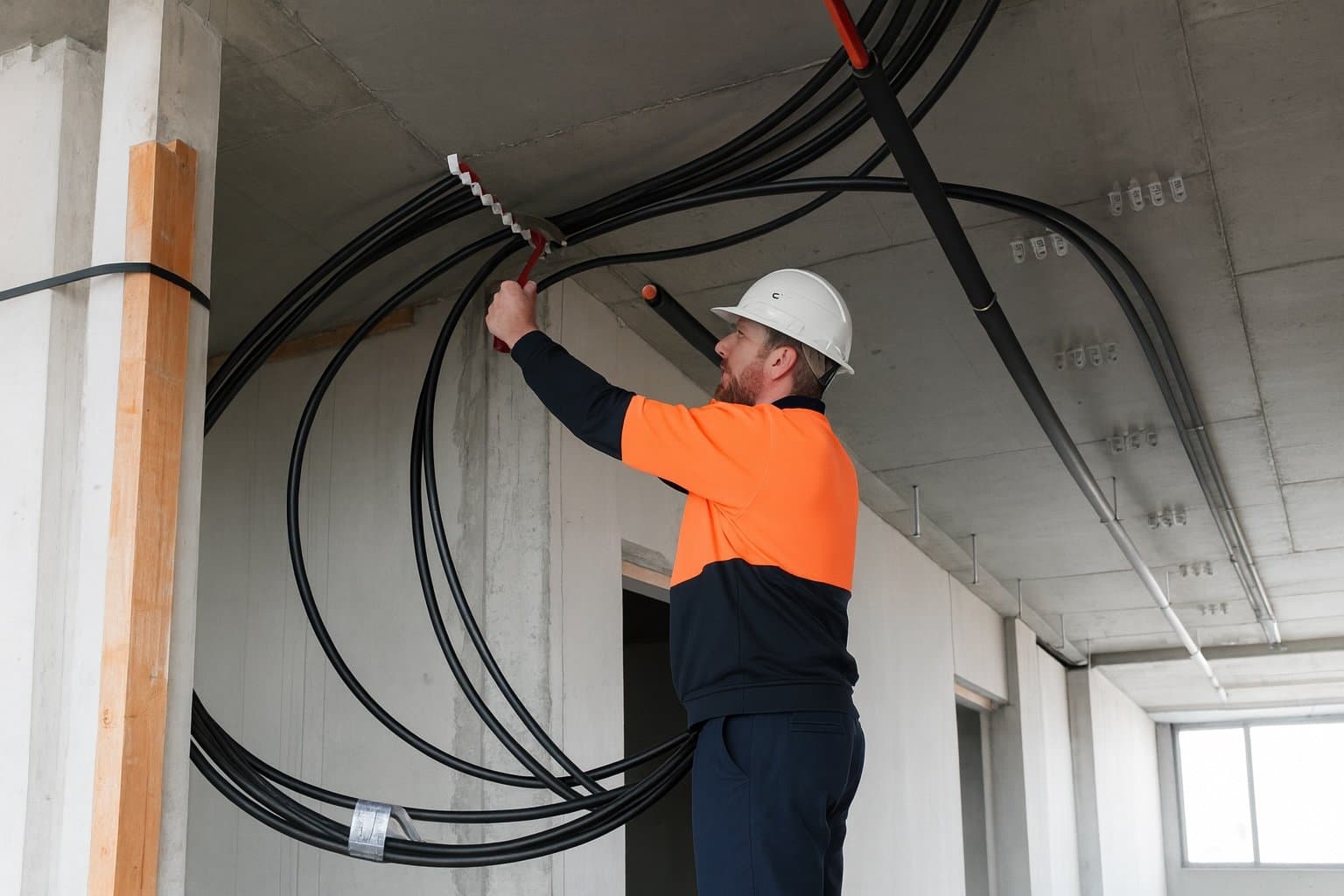 A plumber installing pipes into a roof.